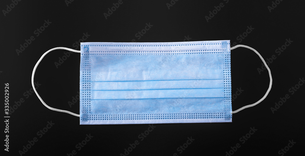 Medical masks, hand sanitizer close up on a dark background Medical masks, hand sanitizer close up on a dark background