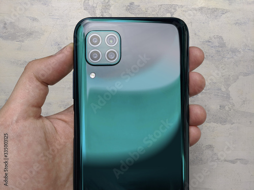 Wallpaper Mural Man hand holding the newest smartphone Torontodigital.ca