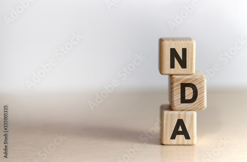 NDA - non disclosure agreement - text on wooden cubes, on white background