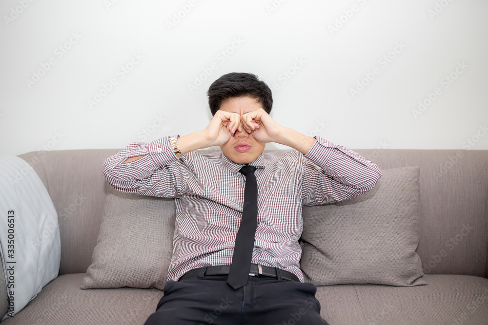 Frustrated businessman feels pain in eyes because of eyesight overstrain after long computer work. Tired young man massaging eyes in front of laptop. Eyes fatigue, headache or migraine at workplace. Frustrated businessman feels pain in eyes because of eyesight overstrain after long computer work. Tired young man massaging eyes in front of laptop. Eyes fatigue, headache or migraine at workplace.