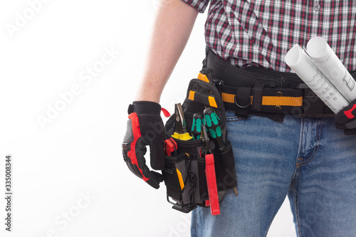 Bild auf Leinwand Electrician or professional Builder in an installer's belt with tools on a white background