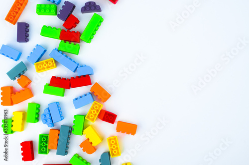 Different colored building blocks scattered across a white isolated background