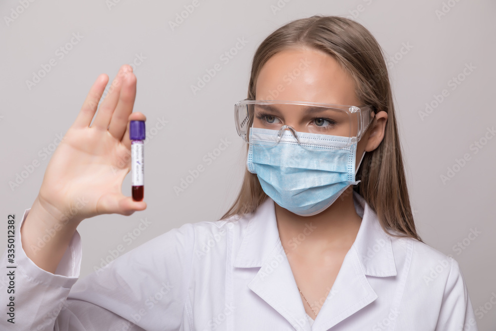 Young woman holding test tubes with blood and antidote in her hand. Coronavirus blood Test tube. Blood Sample in Scientist Hand. Young woman holding test tubes with blood and antidote in her hand. Coronavirus blood Test tube. Blood Sample in Scientist Hand.