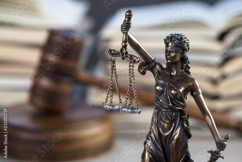 Law and Justice Symbols with law books on background. Law concept image.
