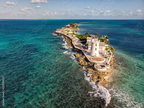 A small exotic island with lighthouse in Bahamas. Pearl island is very popular tourist destination for the guests on a cruise ship. Close to Nassau.