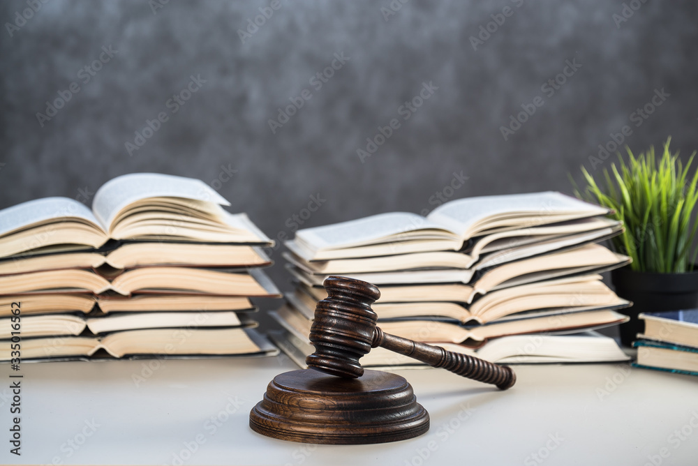 Law and Justice Symbols with law books on background. Law concept image. Law and Justice Symbols with law books on background. Law concept image.