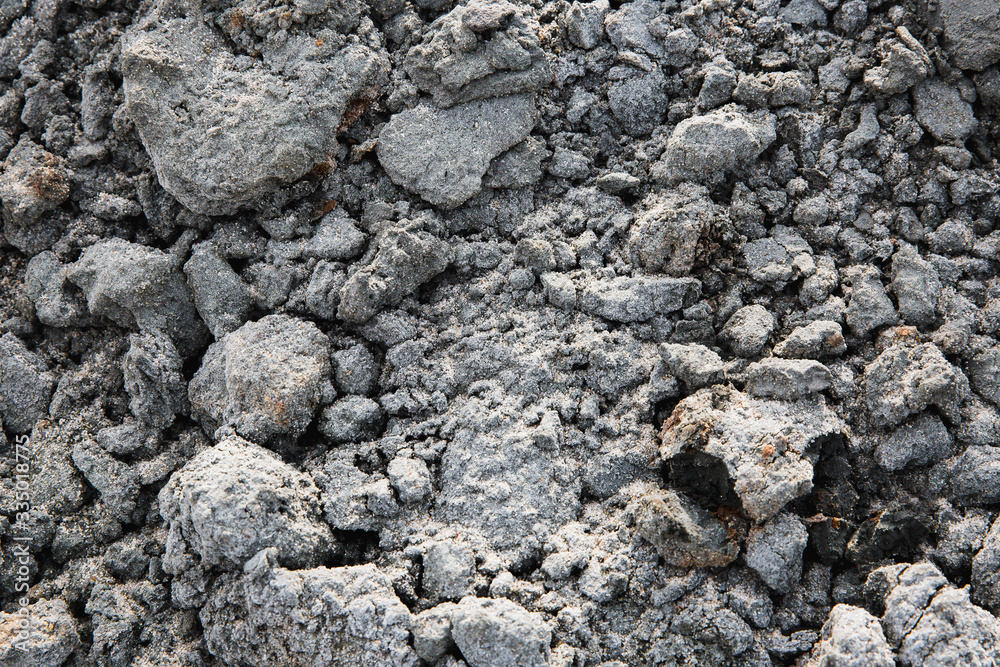 Dirty clods of ground with gray sand, closeup. The texture of natural material. Dirty clods of ground with gray sand, closeup. The texture of natural material.