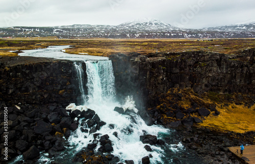 A photographer trying to capture a spectalcular waterfall in Thingvellir  Iceland