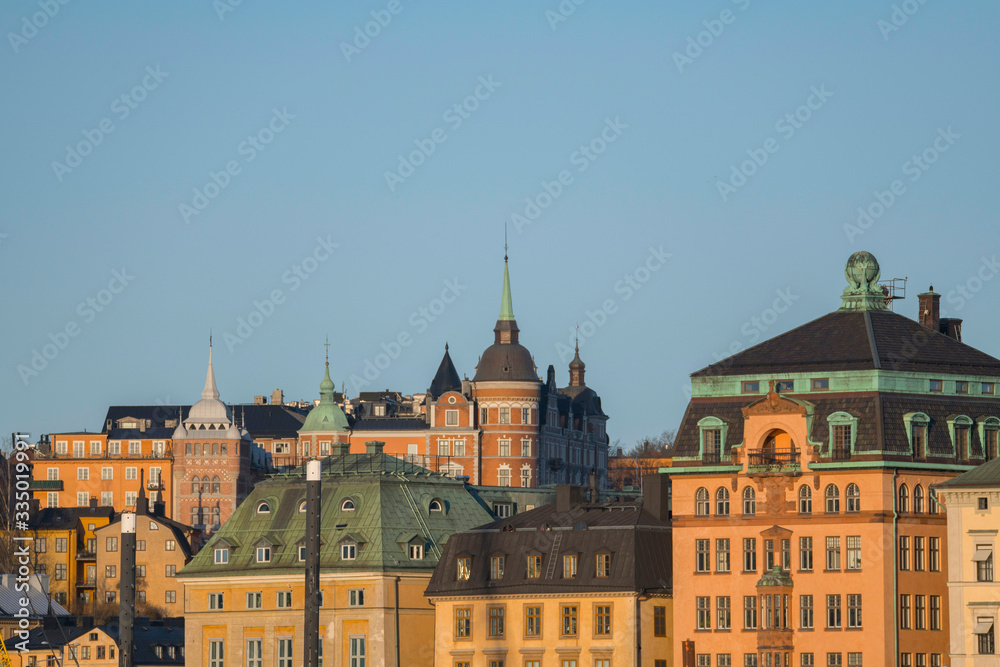 Houses of the old town district Gamla Stan an Södermalm in Stockholm a sunny spring morning.