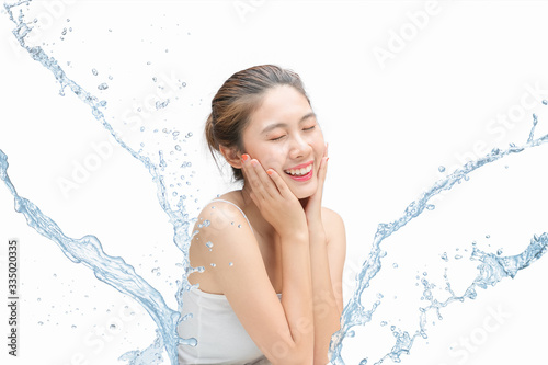 Asian Beautiful model. Beautiful Smiling girl under splash of water with fresh skin on white background.
