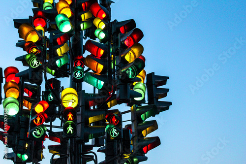 Traffic light tree with a lot of lamps under sky with a sunset. (ID: 335020380)