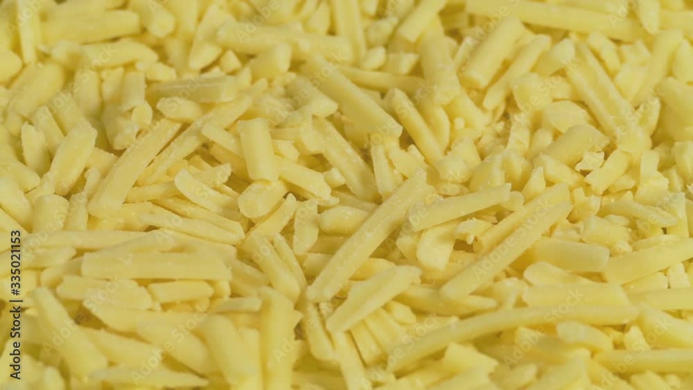 Grated Cheese Turning Slowly Closeup Grated Cheese Turning Slowly Closeup