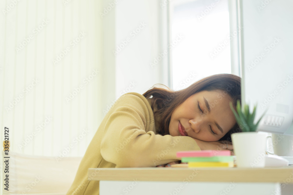 close up young employee woman sleeping at desktop table after feeling asleep in the afternoon for work from home and quarantine time concept close up young employee woman sleeping at desktop table after feeling asleep in the afternoon for work from home and quarantine time concept