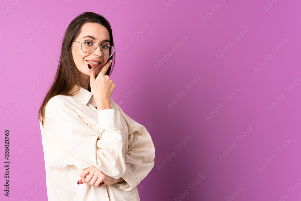 Young woman over isolated purple background happy and smiling Young woman over isolated purple background happy and smiling