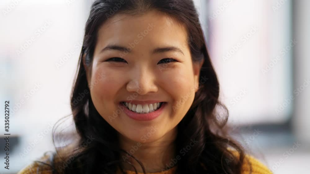 people, ethnicity and race concept - portrait of happy smiling asian young woman at home people, ethnicity and race concept - portrait of happy smiling asian young woman at home