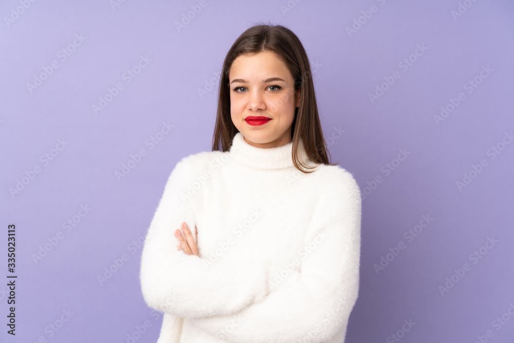 Teenager girl isolated on purple background keeping the arms crossed in frontal position Teenager girl isolated on purple background keeping the arms crossed in frontal position