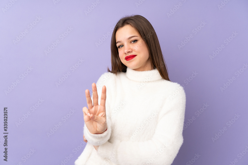 Teenager girl isolated on purple background happy and counting three with fingers Teenager girl isolated on purple background happy and counting three with fingers
