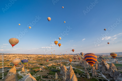 Hot Air balloons flying over amazing rock forms in Cappadocia