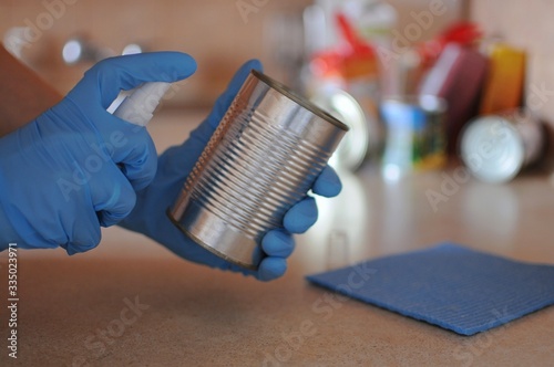 Food home delivery. Disinfecting can after receiving products at home. photo