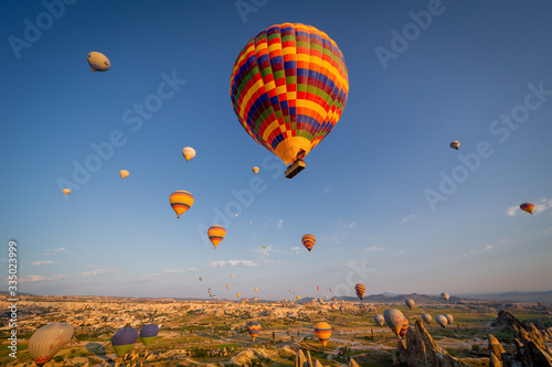 Hot Air balloons flying over amazing rock forms in Cappadocia