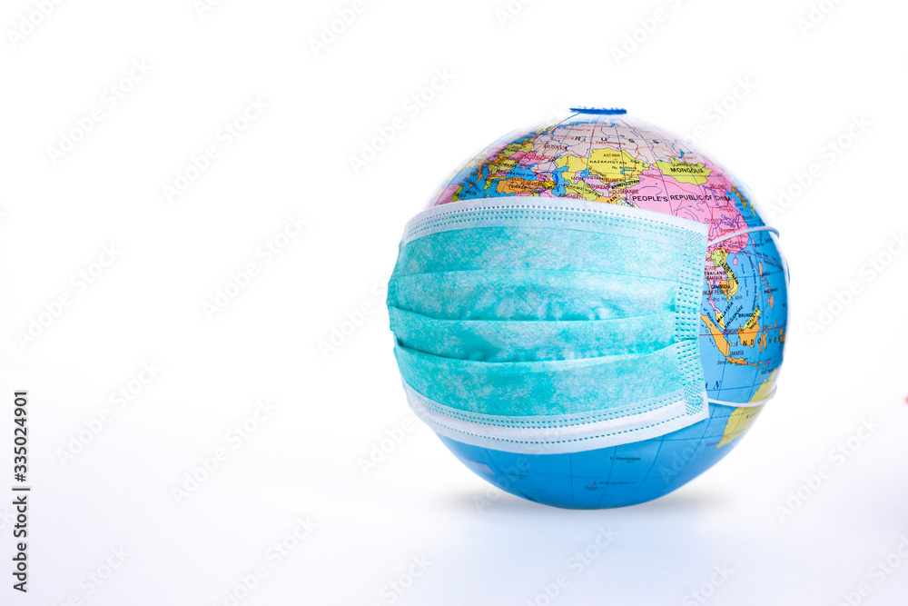 World pandemic concept. Medical mask on globe isolated on white background. Earth viral protection metaphor. World pandemic concept. Medical mask on globe isolated on white background. Earth viral protection metaphor.