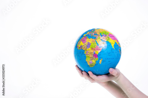 Earth in child hand. World protection concept. Globe in hands isolated on white background. 