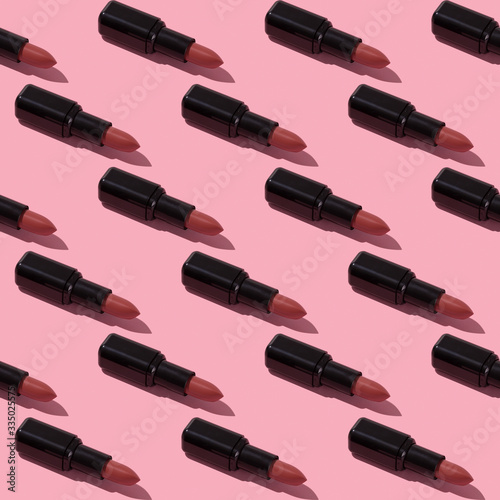 Seamless nude lipstick pattern on pink background.