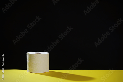 Soft hygienic toilet paper on a black yellow background.