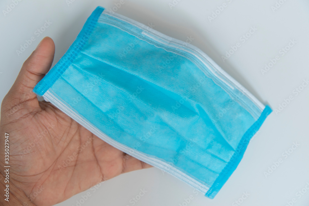 Isolate light blue mask in hand for dust prevention, air pollution, Isolate light blue mask in hand for dust prevention, air pollution,