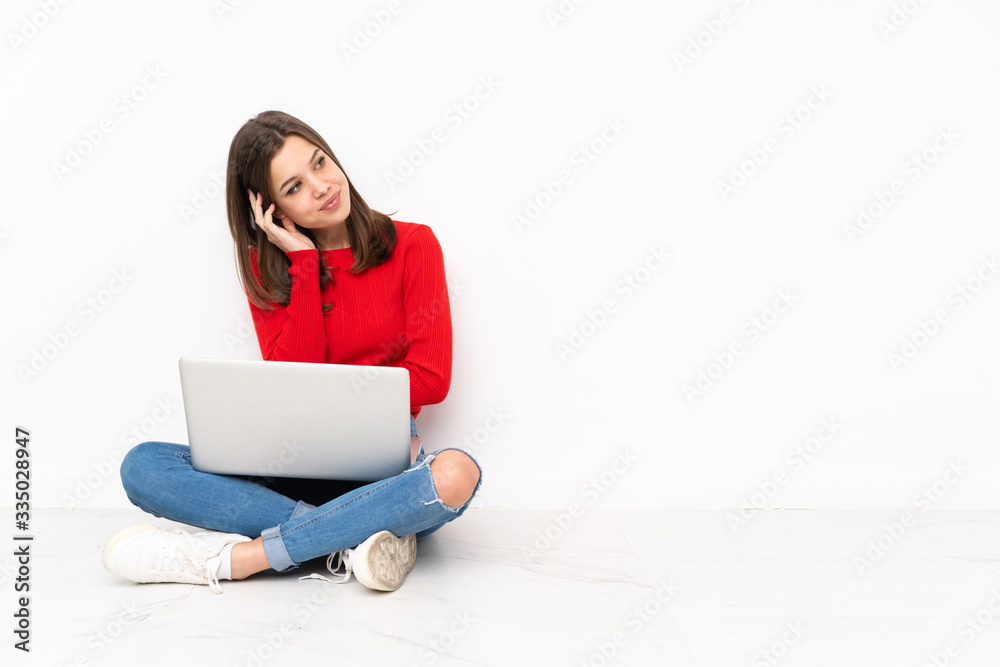 Naklejka premium Tenaager girl working with pc isolated on white background thinking an idea