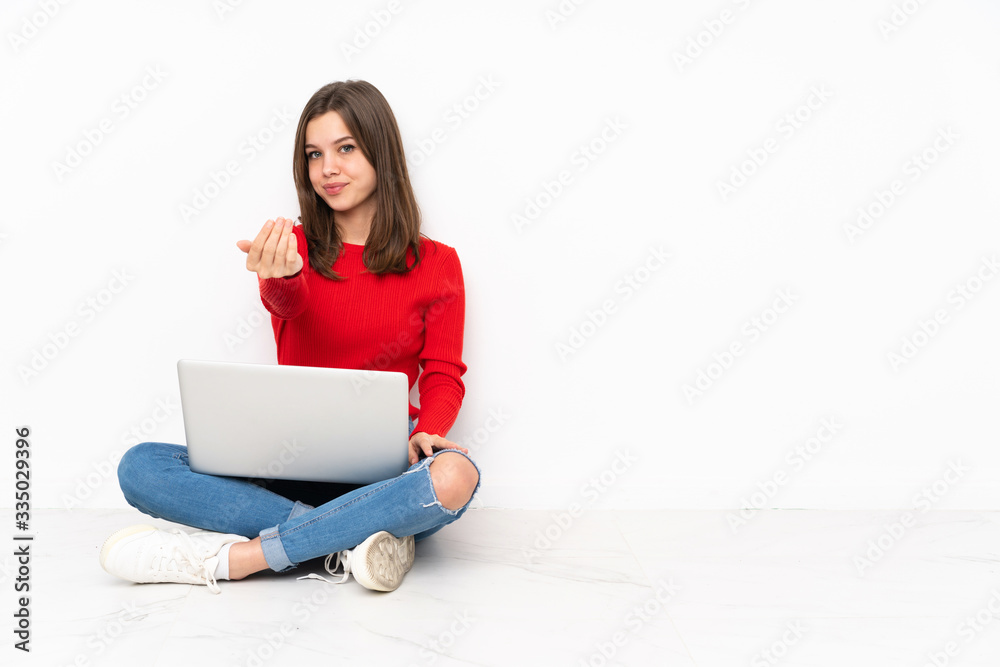 Tenaager girl working with pc isolated on white background inviting to come with hand. Happy that you came Tenaager girl working with pc isolated on white background inviting to come with hand. Happy that you came