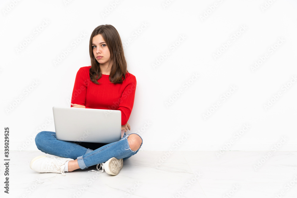 Tenaager girl working with pc isolated on white background with sad and depressed expression