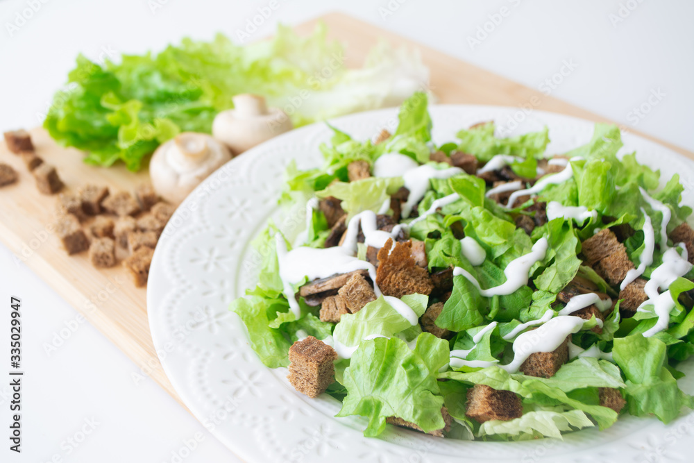 Vegetarian version of classic Caesar salad with mushrooms instead of chicken, croutons, lettuce, parmesan cheese and dressing sauce Vegetarian version of classic Caesar salad with mushrooms instead of chicken, croutons, lettuce, parmesan cheese and dressing sauce