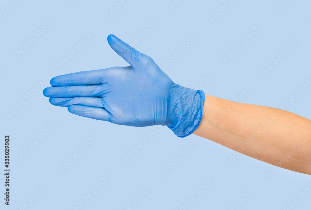 Doctor hand glove shows number five front on blue background. Doctor hand glove shows number five front on blue background.