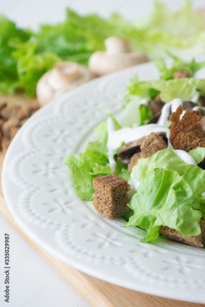 Vegetarian version of classic Caesar salad with mushrooms instead of chicken, croutons, lettuce, parmesan cheese and dressing sauce Vegetarian version of classic Caesar salad with mushrooms instead of chicken, croutons, lettuce, parmesan cheese and dressing sauce