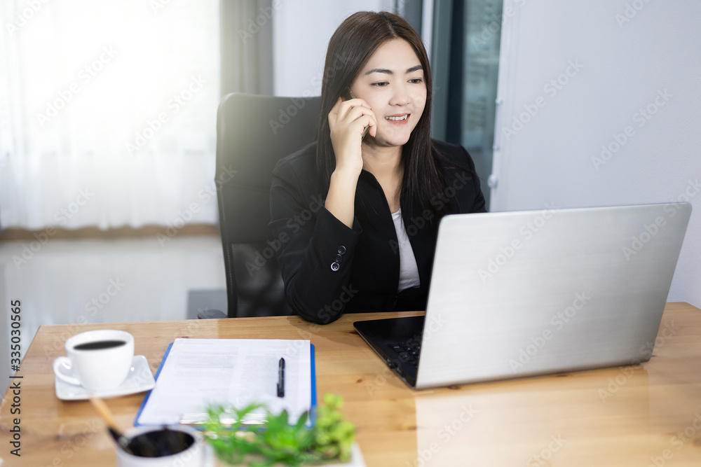 Work from home concept. Asian pretty bussiness woman using laptop and phone. Work from home concept. Asian pretty bussiness woman using laptop and phone.