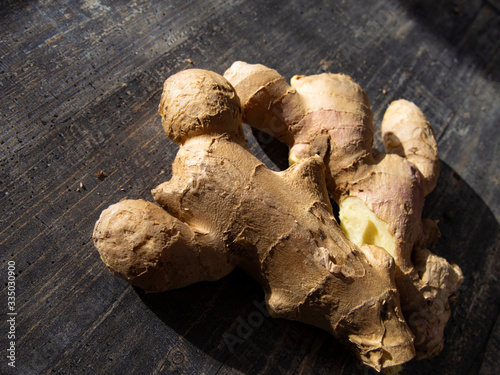 fresh ginger root is lying on a wooden table