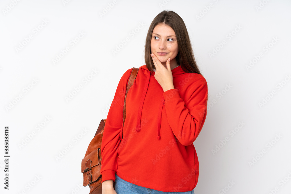 Teenager caucasian student girl isolated on white background thinking an idea Teenager caucasian student girl isolated on white background thinking an idea
