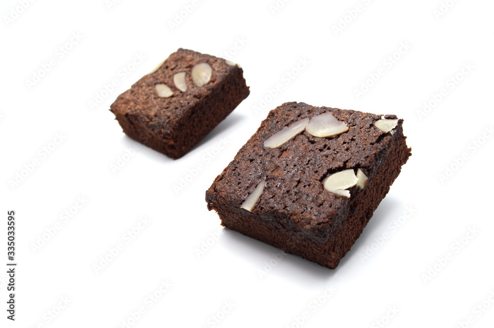 Chocolate brownie with sliced almond nuts toppings isolated on white background. Chocolate brownie with sliced almond nuts toppings isolated on white background.