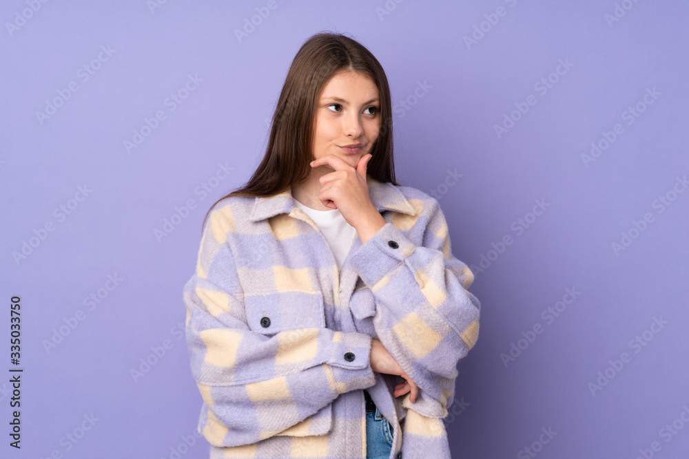 Teenager caucasian girl isolated on purple background thinking an idea while looking up Teenager caucasian girl isolated on purple background thinking an idea while looking up