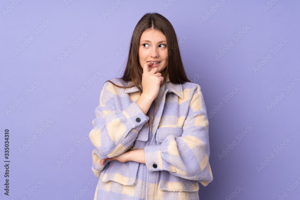 Teenager caucasian girl isolated on purple background nervous and scared Teenager caucasian girl isolated on purple background nervous and scared