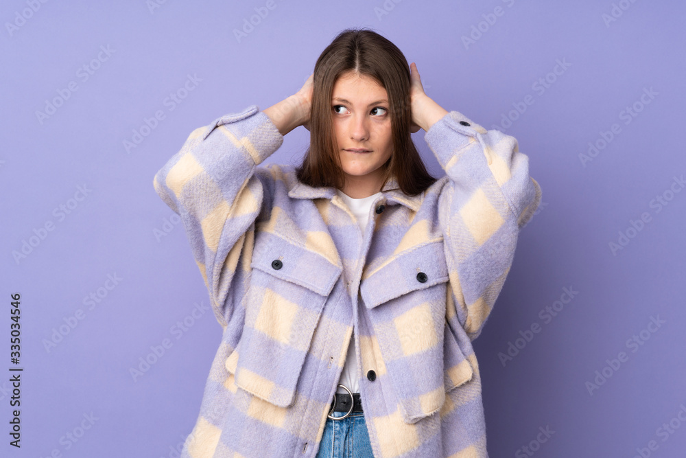 Teenager caucasian girl isolated on purple background frustrated and covering ears Teenager caucasian girl isolated on purple background frustrated and covering ears