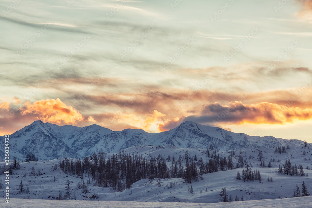 Beautiful winter landscape with mountains at sunset. Altai. Russia