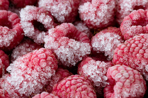 Freshly frozen raspberries with ice crystals