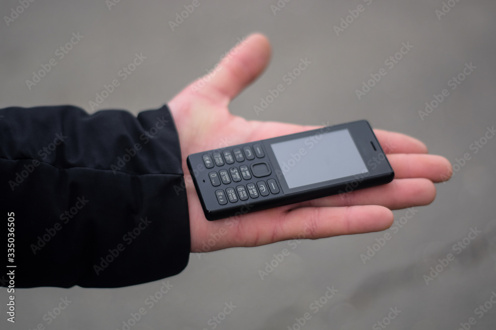 Telephone with buttons on a man's hand close up Telephone with buttons on a man's hand close up
