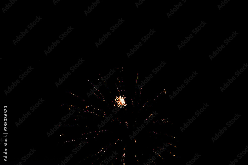 Obraz premium Salutes against the black sky, bright flashes, comets and shooting stars in the dark.