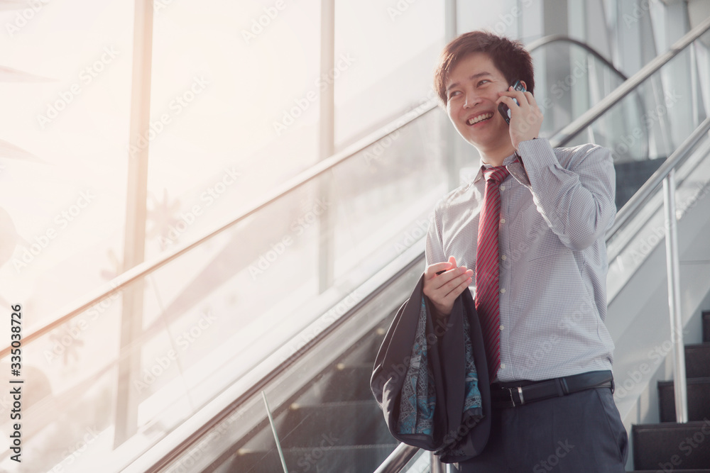 Handsome smiling confident businessman talking something on smart phone. Handsome smiling confident businessman talking something on smart phone.