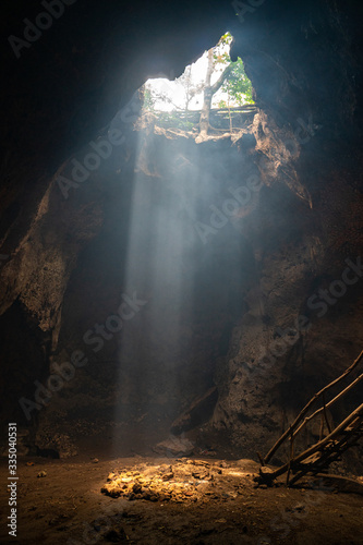 bat cave on Lombok with beautiful sun rays coming in from the top. 