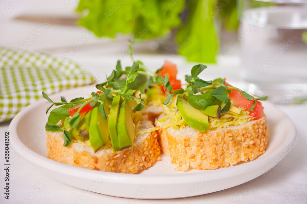 sliced avocado on toast bread with herbs. sliced avocado on toast bread with herbs.
