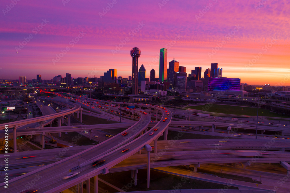 Dallas skyline with pink sky and highways